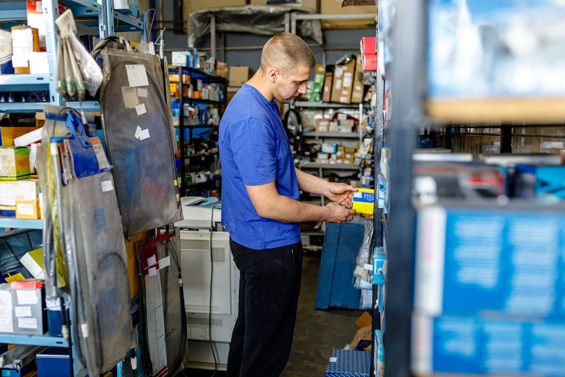 A Car Mechanic is Trying to Repair a Car Failure and Looking for Car Parts.